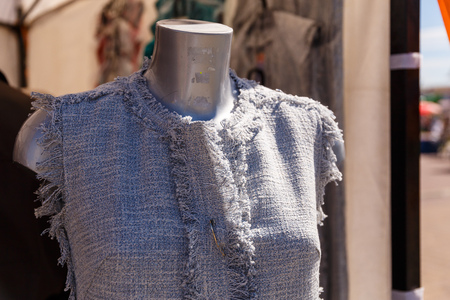 Summer female dress hanging on a mannequin in a women's clothing store on the streetの写真素材