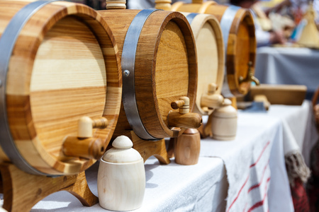 Wooden hand-made barrels stand in a row on the street