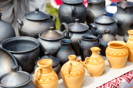 Clay handmade pots are sold at the exhibition of folk handicrafts