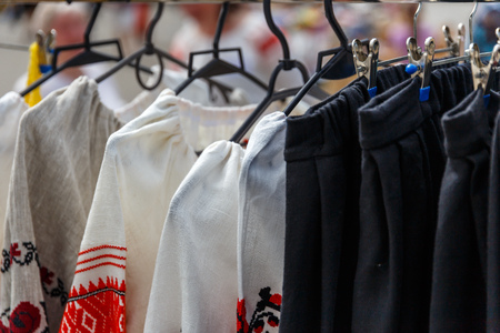 National Belarusian clothes hanging on hangers in the storeの写真素材
