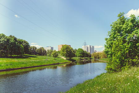 Green park with a lake in the center of the city I have a clear sunny summer weatherの写真素材