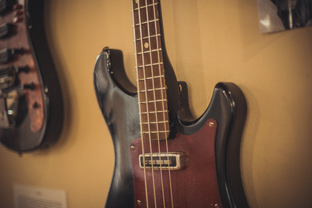 Retro bass guitar in vintage style on shelves in a musical instrument storeの写真素材