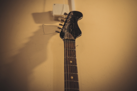 Retro bass guitar in vintage style on shelves in a musical instrument storeの写真素材