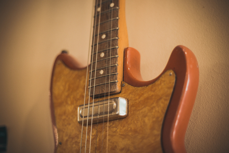 Retro bass guitar in vintage style on shelves in a musical instrument storeの写真素材