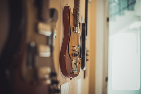 Retro bass guitar in vintage style on shelves in a musical instrument storeの写真素材