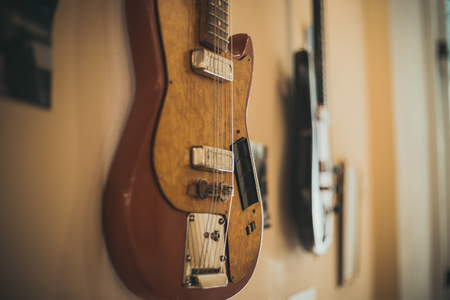 Retro bass guitar in vintage style on shelves in a musical instrument storeの写真素材
