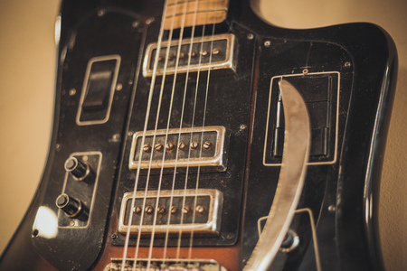 Retro bass guitar in vintage style on shelves in a musical instrument storeの写真素材