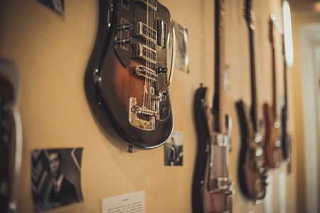 Retro bass guitar in vintage style on shelves in a musical instrument storeの写真素材