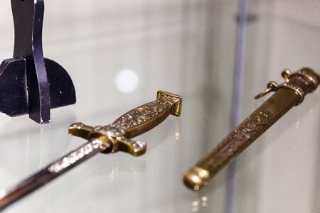 daggers knives saber swords lie on the surface in a private collectionの写真素材
