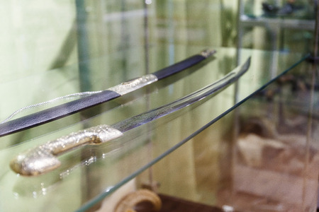 daggers knives saber swords lie on the surface in a private collectionの写真素材