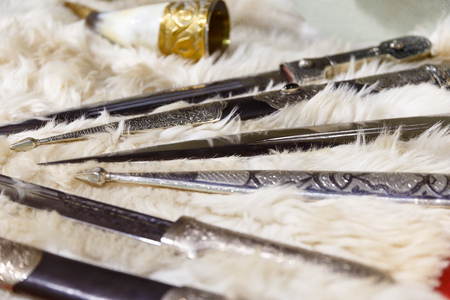 daggers knives saber swords lie on the surface in a private collectionの写真素材