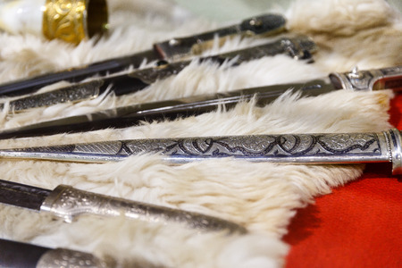 daggers knives saber swords lie on the surface in a private collectionの写真素材