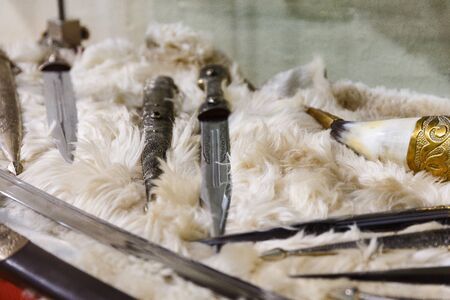 daggers knives saber swords lie on the surface in a private collectionの写真素材