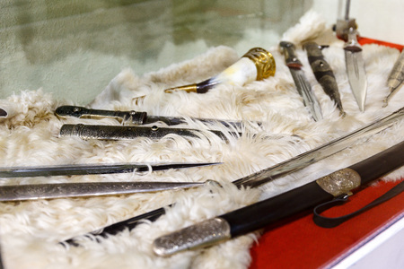 daggers knives saber swords lie on the surface in a private collectionの写真素材