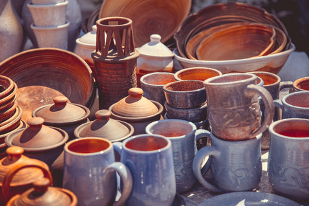 Clay pots and mugs are sold under the open sky
