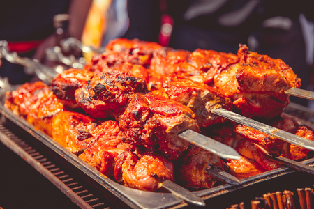 A barbecue is fried on an open air charcoal grillの写真素材