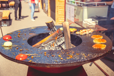 On a round clay brazier fried food