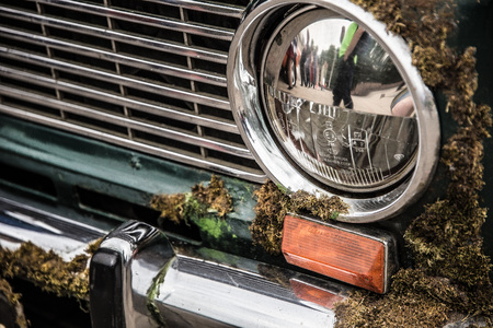 Old rusty submerged car with moss on the bodyの写真素材