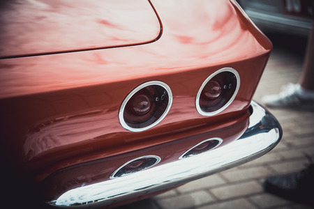 Headlights and body of an old classic car at an exhibition of vintage cars