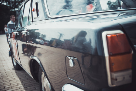 Headlights and body of an old classic car at an exhibition of vintage carsの写真素材