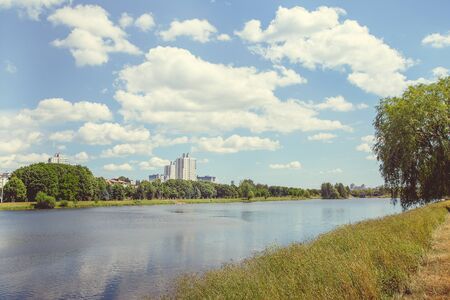 Park with a lake in the center of the city in a hot, sunny summer weather
