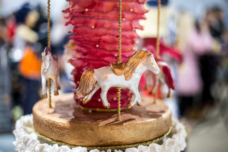 A beautiful cake in the form of a fairy-tale creature made of mastic and biscuitの写真素材