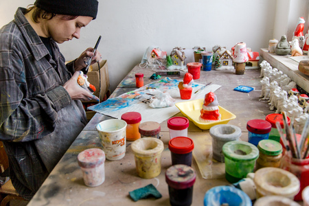 girl paints Christmas toys at a factory of Christmas toysのeditorial素材