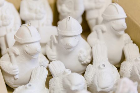 unpainted blanks of Christmas-tree toys in the warehouse of the factory for making Christmas-tree toysの写真素材