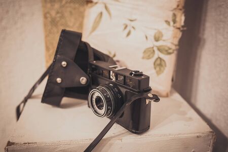 Vintage film camera with leather case on white backgroundの写真素材