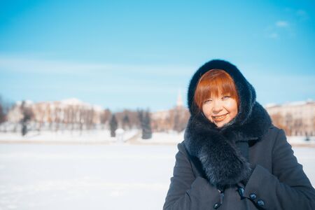 MINSK, BELARUS - February 1, 2017: Portrait of a happy beautiful girl with red hair in the field, lifestyleのeditorial素材