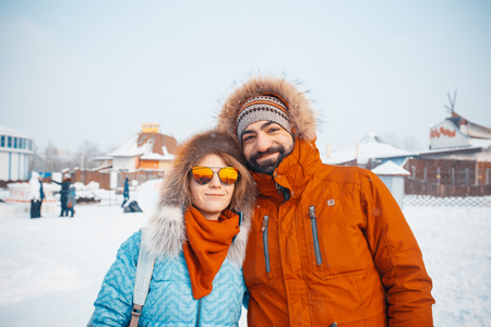 MINSK, BELARUS - February 1, 2017: Happy Young Couple in Winter . Family Outdoors. man and woman looking upwards and laughingのeditorial素材