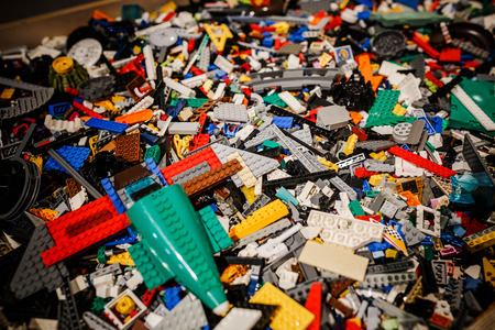 Many assorted building bricks of bright colors. Educational toy for children