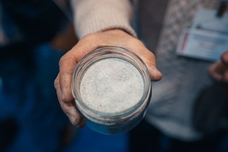 olivine and quartz powder in a jar