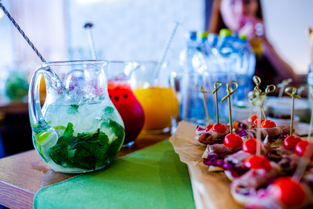 Buffet table of reception with burgers, cold snacks, meat and saladsの写真素材