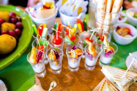 Buffet table of reception with burgers, cold snacks, meat and saladsの写真素材