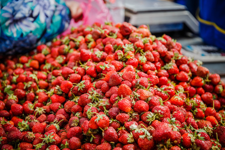 Vivid colorful red strawberries on the fruit marketの写真素材