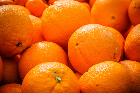Fresh organic oranges on display on sunny day.の写真素材