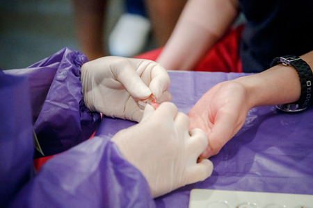 Taking blood for close-up analysis, a clinical blood testの写真素材