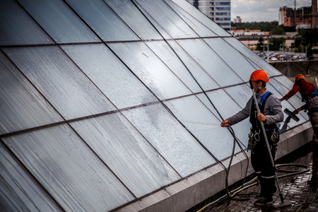 MINSK, BELARUS - 02 JUNE. 2018: group of workers cleaning windows service on high rise building. work on the heights , industrial mountaineeringのeditorial素材