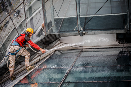 MINSK, BELARUS - 02 JUNE. 2018: group of workers cleaning windows service on high rise building. work on the heights , industrial mountaineeringのeditorial素材
