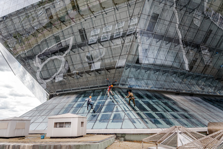 MINSK, BELARUS - 02 JUNE. 2018: group of workers cleaning windows service on high rise building. work on the heights , industrial mountaineeringのeditorial素材