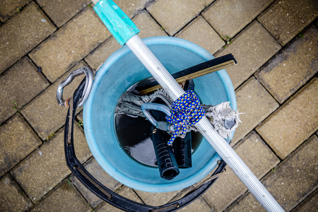 bucket with dirty water after washing windows by industrial climbersの写真素材