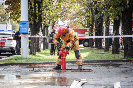 MINSK, BELARUS - MAY 1, 2017: the fireman pumps water from the hydrantのeditorial素材