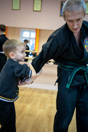 MINSK, BELARUS - 25 DECEMBER, 2018: children train with martial arts trainer viet daoのeditorial素材