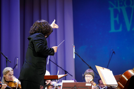 MINSK, BELARUS - 1 APRIL, 2019: Conductor directing symphony orchestraのeditorial素材
