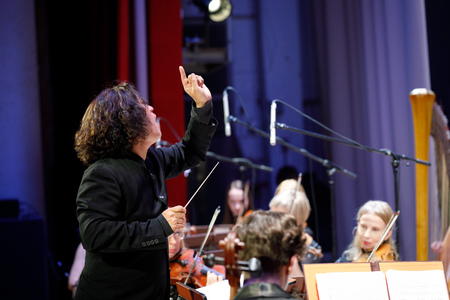 MINSK, BELARUS - 1 APRIL, 2019: Conductor directing symphony orchestraのeditorial素材
