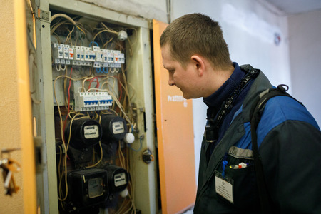MINSK, BELARUS - 1 APRIL, 2019: electrician checks switchboardのeditorial素材