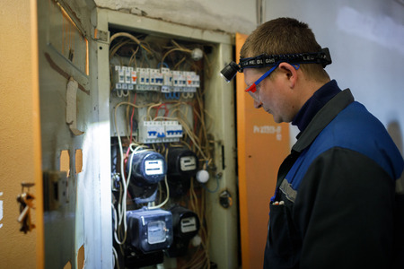 MINSK, BELARUS - 1 APRIL, 2019: electrician checks switchboardのeditorial素材