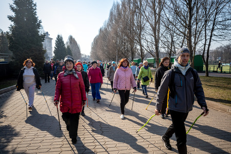 MINSK, BELARUS - 1 MARTH, 2019: older people doing Nordic walking exercisesのeditorial素材