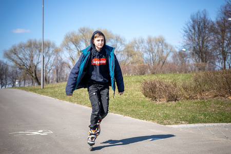 MINSK, BELARUS - 1 MARTH, 2019: children and adults walk in the park and ride roller skates and...